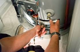 water heater repair technician servicing tank